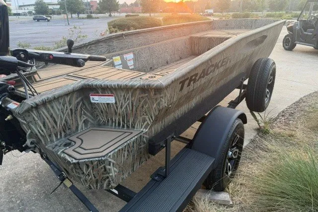 Slide: The Image of 2026 Tracker Grizzly 1650 T Prairie Wings Edition boat on trailer, camo design, parked outdoors. - 3