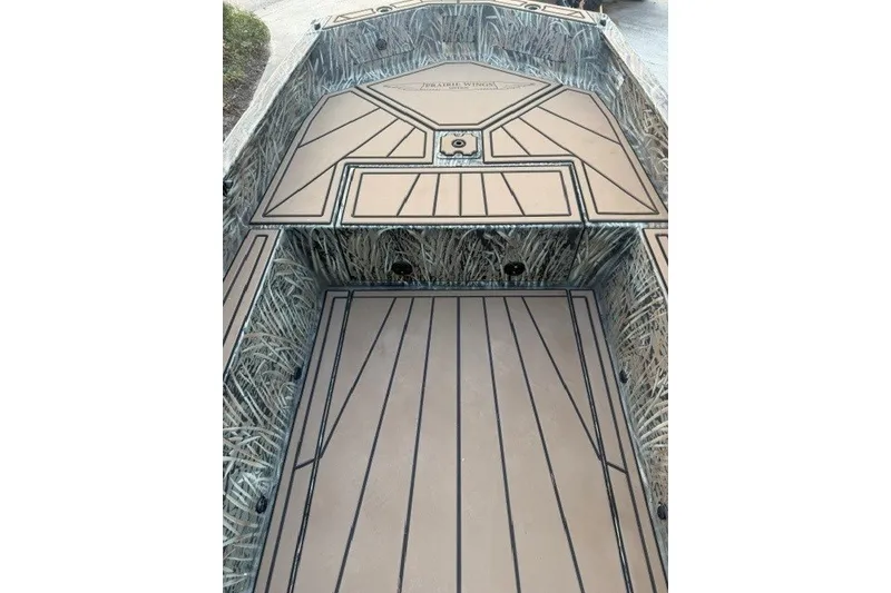 Slide: The Image of 2026 Tracker Grizzly 1650 T Prairie Wings Edition boat interior with camo design. - 7