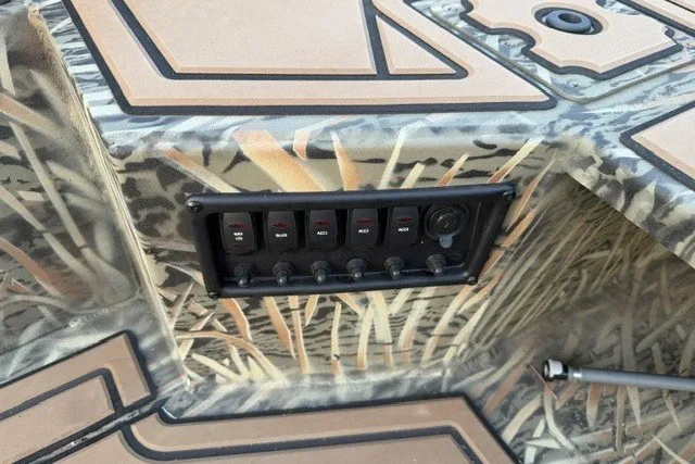 Slide: The Image of Control panel of 2026 Tracker Grizzly 1650 T Prairie Wings Edition boat with camouflage design. - 12