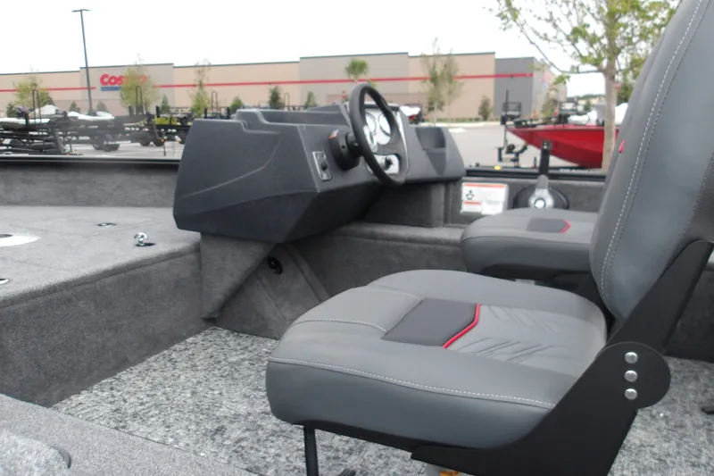 Slide: The Image of 2026 Tracker Pro Guide V-16 SC boat interior with gray seating and steering console. - 15