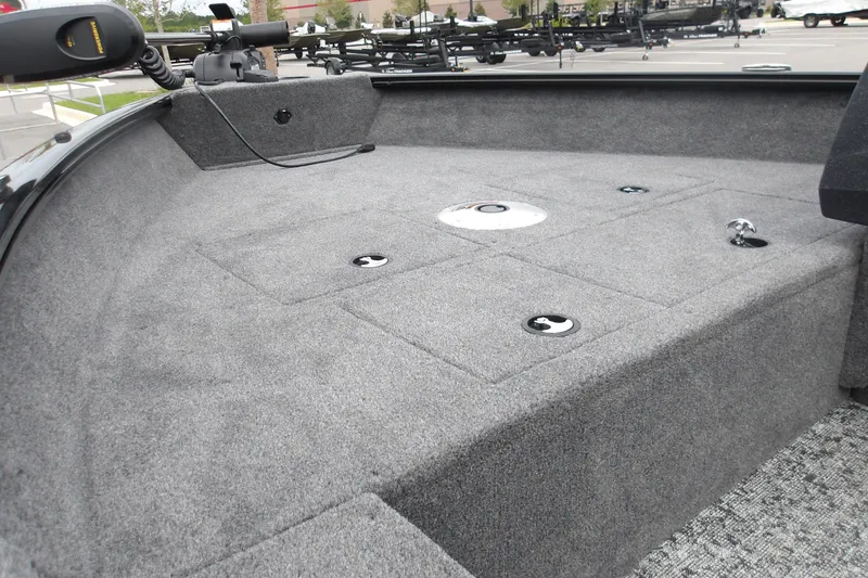 Slide: The Image of 2026 Tracker Pro Guide V-16 SC boat interior with carpeted deck and storage compartments. - 16