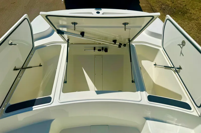 Slide: The Image of Open storage compartments on a 2026 Mako Pro Skiff 19 CC boat. - 18