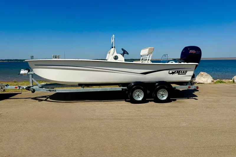 Slide: The Image of 2026 Mako Pro Skiff 19 CC boat on trailer by the waterfront. - 16