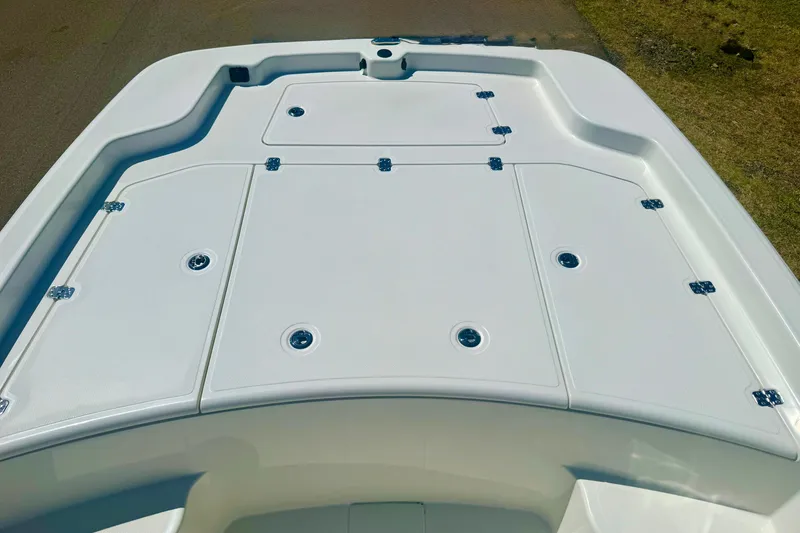 Slide: The Image of 2026 Mako Pro Skiff 19 CC boat deck with storage compartments. - 17