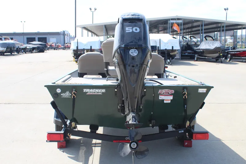 Slide: The Image of 2026 Tracker Bass Tracker Classic Limited boat with 50 HP motor, displayed outdoors. - 45