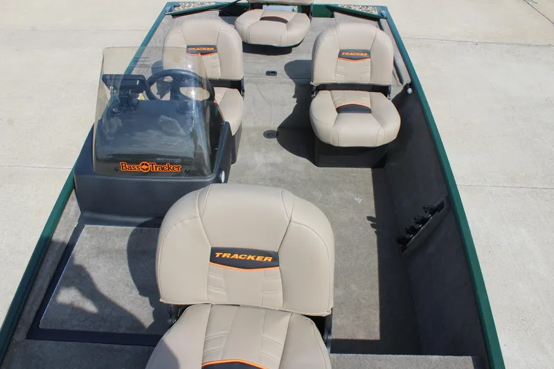 Slide: The Image of 2026 Tracker Bass Tracker Classic Limited boat interior with beige seats and steering console. - 51