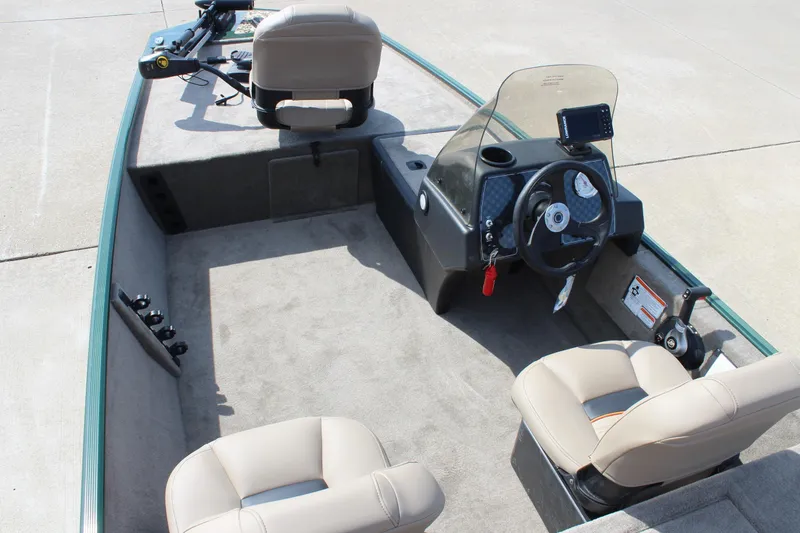 Slide: The Image of 2026 Tracker Bass Tracker Classic Limited boat interior with steering console and seating. - 56