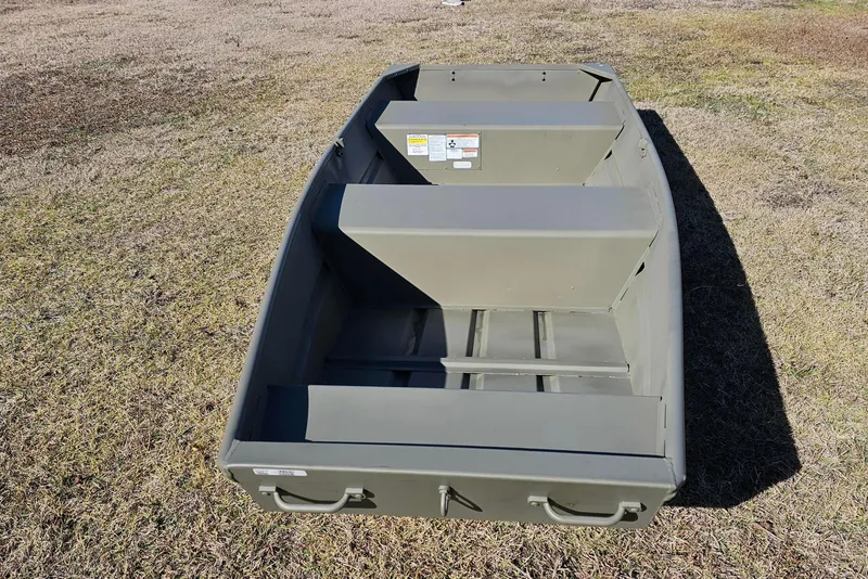 Slide: The Image of 2026 Tracker Grizzly 12 Jon boat on grass, showcasing its sturdy design and spacious interior. - 4