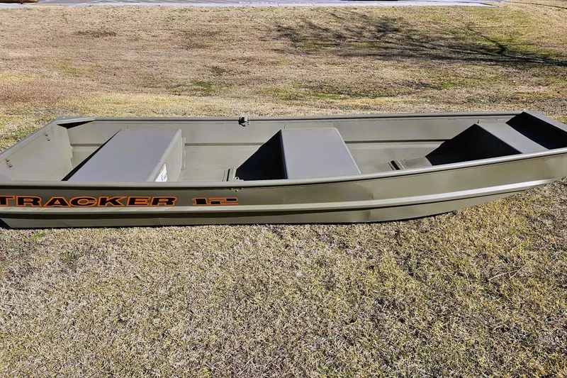 Slide: The Image of 2026 Tracker Grizzly 12 Jon boat on grass, showcasing its sturdy design and spacious interior. - 5