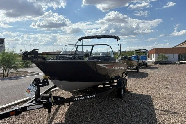 The Image of 2026 Tracker Pro Guide V-175 Combo boat on trailer under a partly cloudy sky. - 0