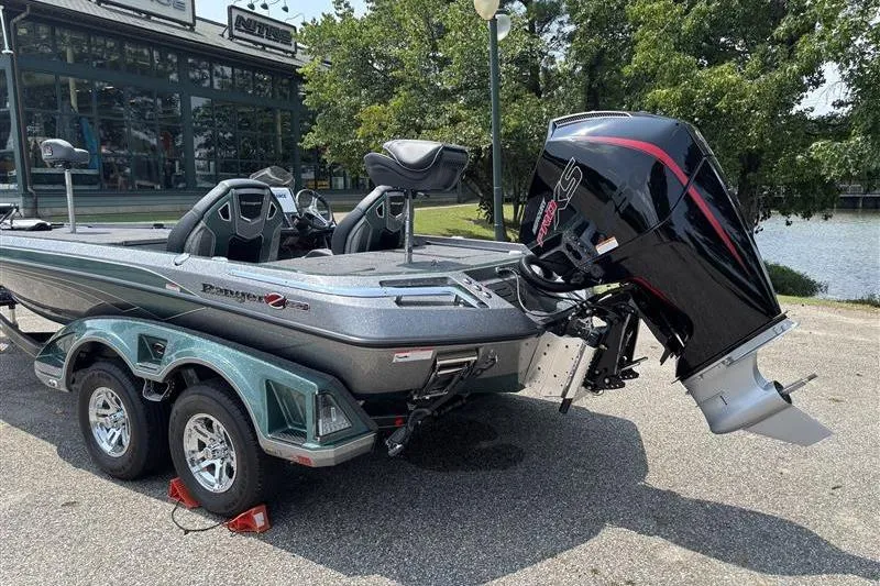 Slide: The Image of 2026 Ranger Z520R Cup-Equipped boat with powerful outboard motor, parked near a lake. - 4