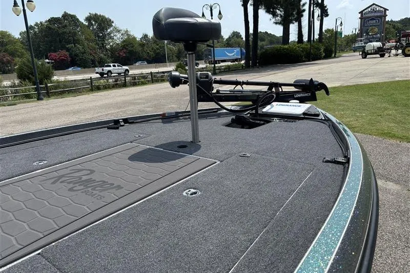 Slide: The Image of 2026 Ranger Z520R Cup-Equipped boat deck with fishing seat and equipment, parked outdoors. - 11