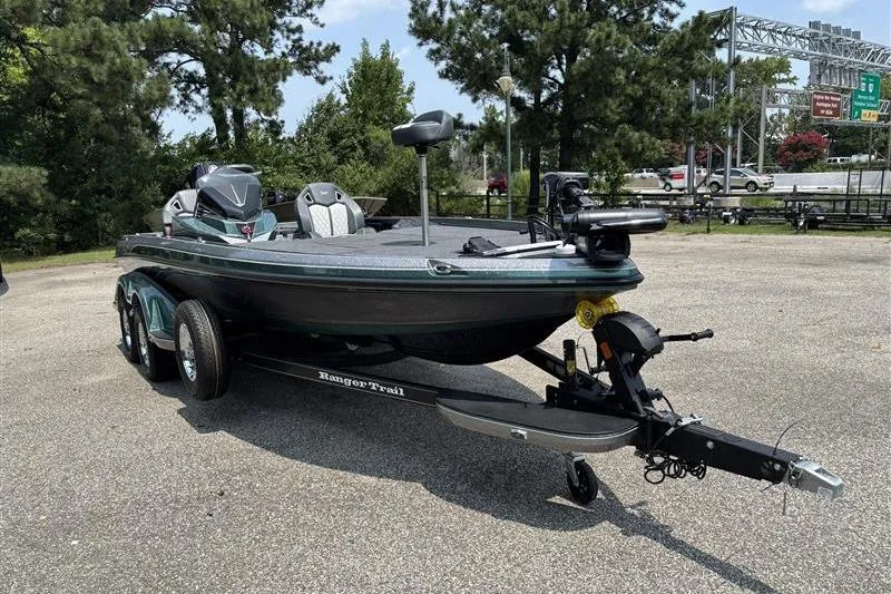 Slide: The Image of 2026 Ranger Z520R Cup-Equipped boat on trailer in parking lot, surrounded by trees. - 6