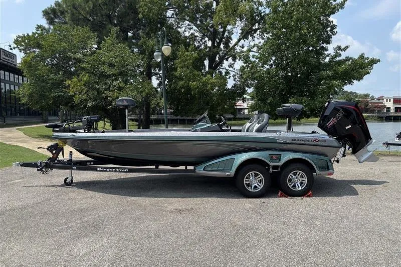 The Image of 2026 Ranger Z520R Cup-Equipped boat on trailer, parked outdoors near trees and water. - 0
