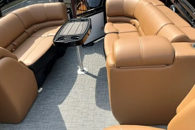 Slide: The Image of Luxurious seating area on 2026 Regency 250 DL boat with tan upholstery and central table. - 14