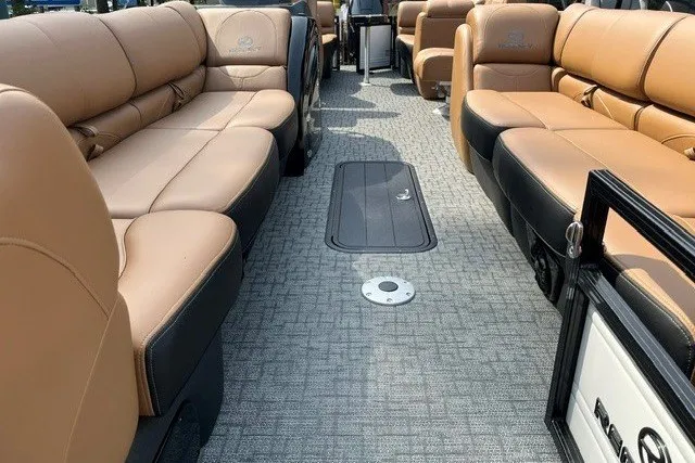 Slide: The Image of Luxurious interior of 2026 Regency 250 DL pontoon boat with tan seating and gray flooring. - 5