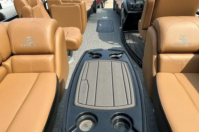 Slide: The Image of Luxurious interior of 2026 Regency 250 DL boat with tan leather seating and cup holders. - 84