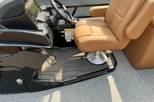 Slide: The Image of Captain's chair and helm of 2026 Regency 250 DL boat, featuring sleek design and controls. - 13