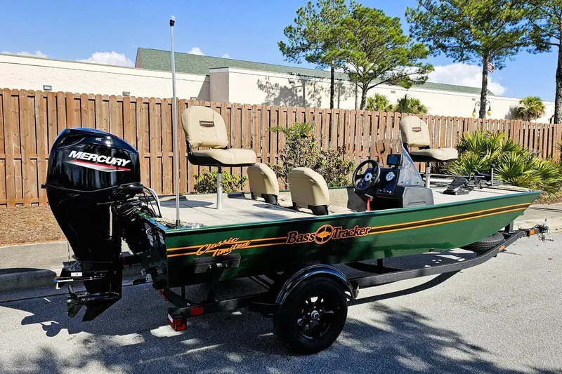 The Image of 2026 Tracker Bass Tracker Classic Limited boat with Mercury engine, parked outdoors. - 0