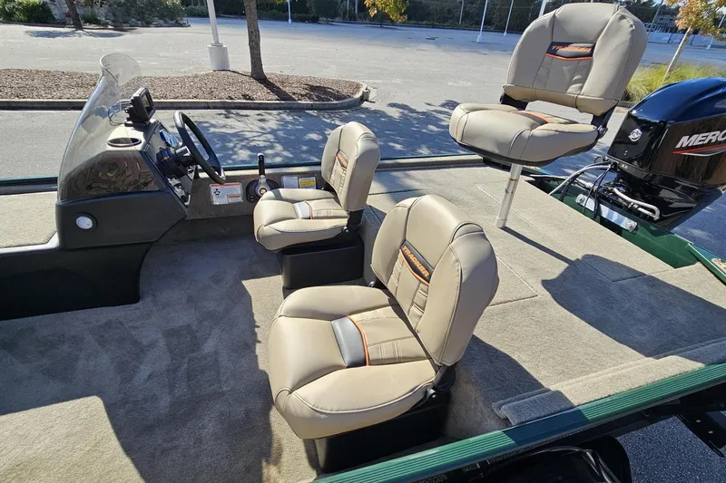 Slide: The Image of 2026 Tracker Bass Tracker Classic Limited boat interior with beige seats and steering console. - 10
