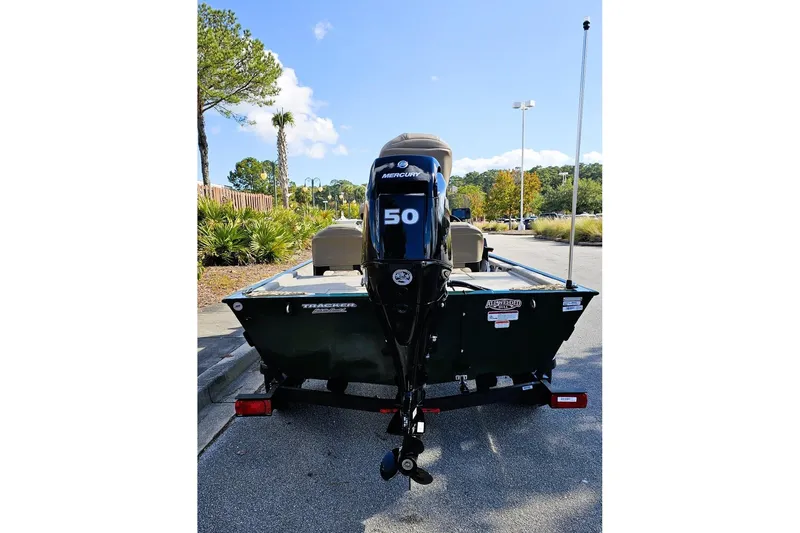 Slide: The Image of 2026 Tracker Bass Tracker Classic Limited boat with Mercury 50 engine in parking lot. - 11