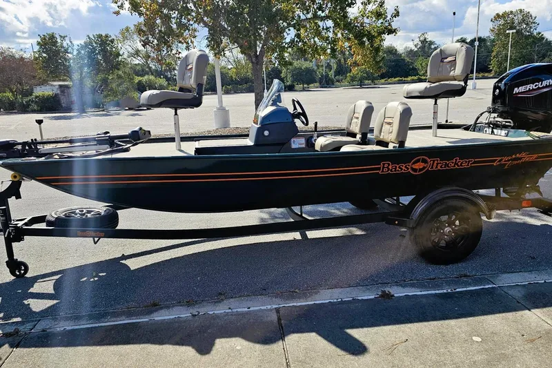 Slide: The Image of 2026 Tracker Bass Tracker Classic Limited boat on trailer in sunny parking lot. - 5