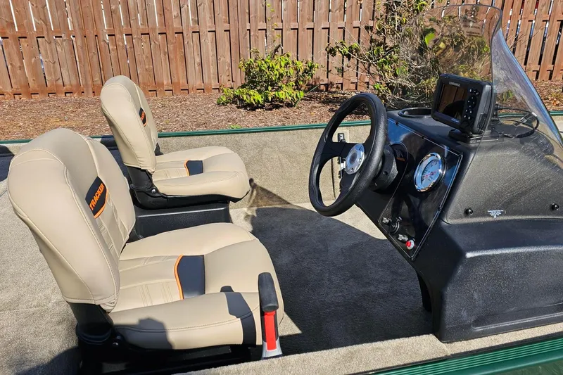 Slide: The Image of 2026 Tracker Bass Tracker Classic Limited boat interior with beige seats and steering console. - 9