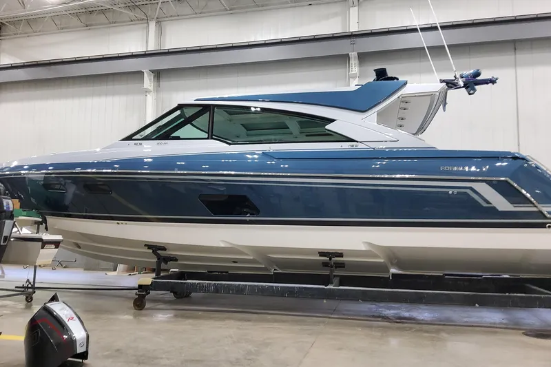 Slide: The Image of 2026 Formula 500 Super Sport Crossover boat in a showroom, showcasing sleek design and modern features. - 2