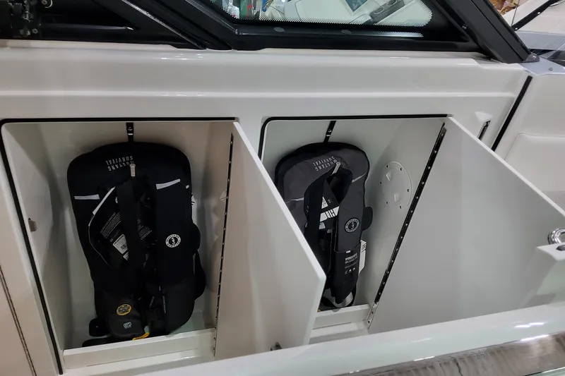 Slide: The Image of Storage compartments with life jackets on a 2026 Formula 500 Super Sport Crossover boat. - 21