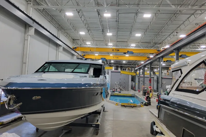 Slide: The Image of 2026 Formula 500 Super Sport Crossover boats in a spacious indoor facility. - 3