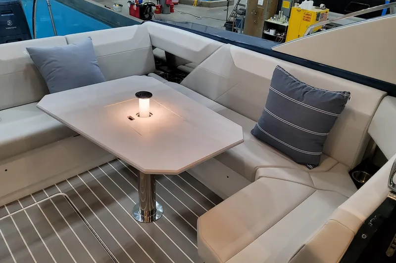 Slide: The Image of Luxurious seating area on 2026 Formula 500 Super Sport Crossover yacht with elegant table and cushions. - 8
