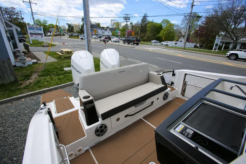 Slide: The Image of 2026 Navan C30 boat with dual Mercury engines, parked near a street. - 10