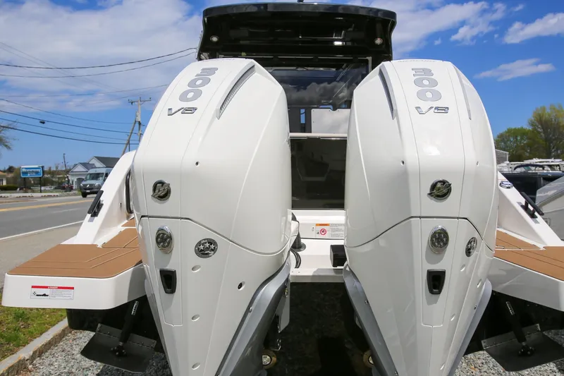 Slide: The Image of 2026 Navan C30 boat with dual 300 V8 engines, docked under a clear blue sky. - 13