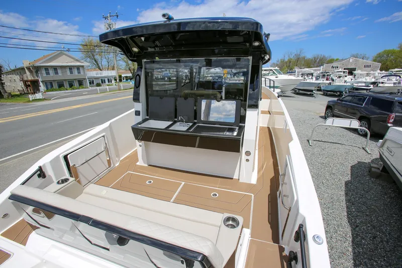 Slide: The Image of 2026 Navan C30 boat interior with seating and console, displayed outdoors. - 14