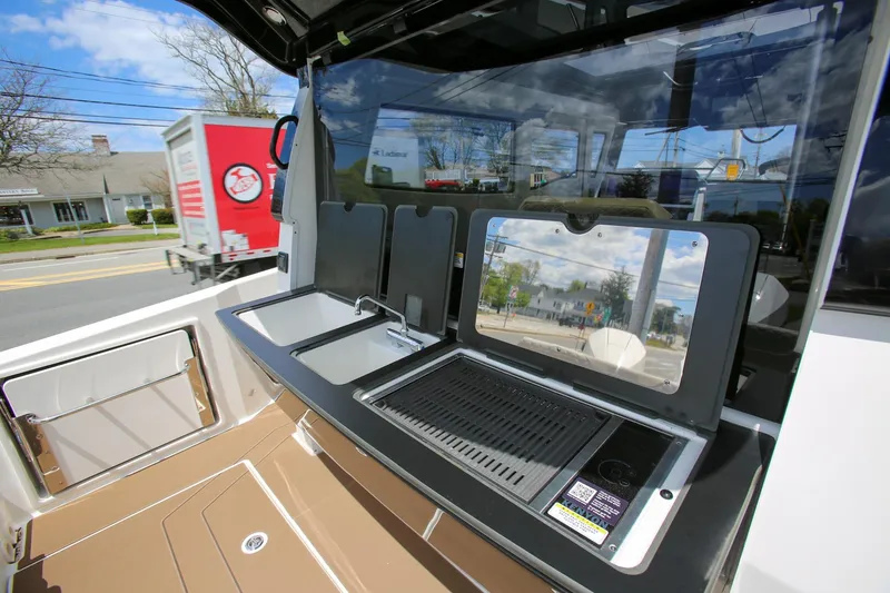 Slide: The Image of Outdoor kitchen setup on a 2026 Navan C30 boat, featuring a sink and grill. - 15