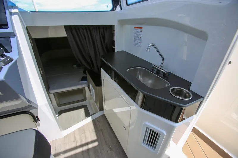 Slide: The Image of Compact kitchen area in 2026 Navan C30 boat with sink and storage. - 19