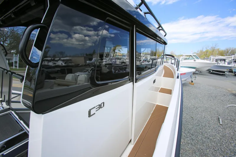 Slide: The Image of 2026 Navan C30 boat with sleek design, docked under a clear blue sky. - 9