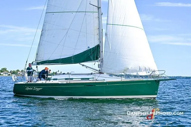 Slide: The Image of 2005 Beneteau First 36.7 sailboat on water, green hull, white sails, clear sky. - 10