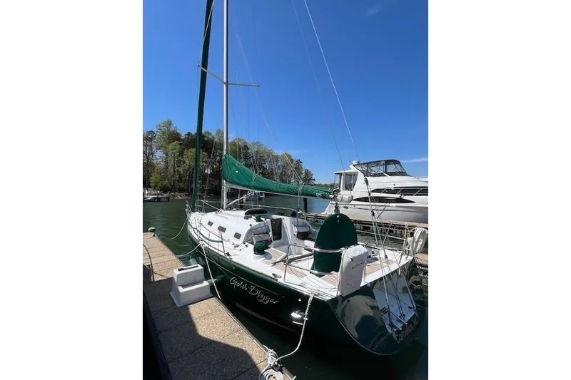 Slide: The Image of 2005 Beneteau First 36.7 sailboat docked, green hull, sunny day, marina background. - 14