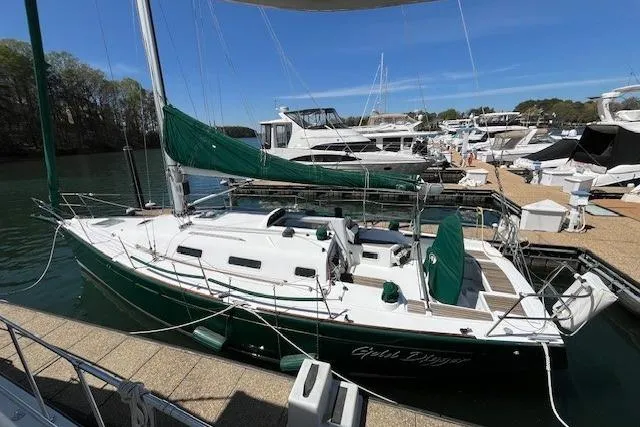 Slide: The Image of 2005 Beneteau First 36.7 sailboat docked at marina with green sails. - 3