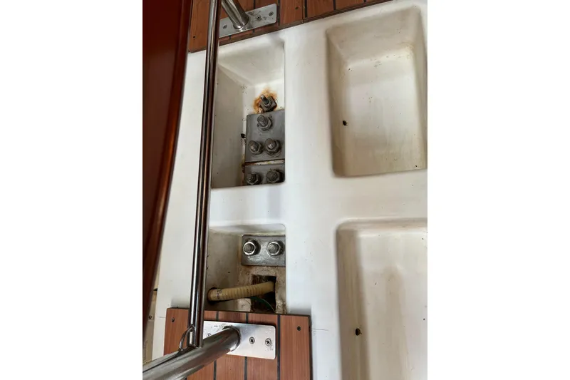 Slide: The Image of Beneteau First 36.7 (2005) sailboat deck detail with metal fittings and wooden accents. - 30