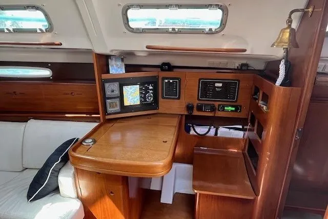 Slide: The Image of 2005 Beneteau First 36.7 yacht interior with navigation station and wooden cabinetry. - 32