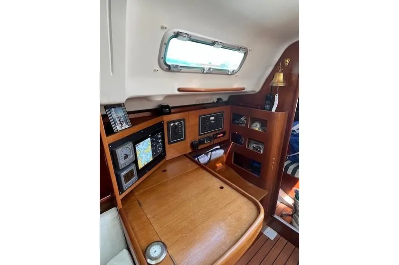 Slide: The Image of Navigation station inside a 2005 Beneteau First 36.7 sailboat, featuring control panels and equipment. - 33