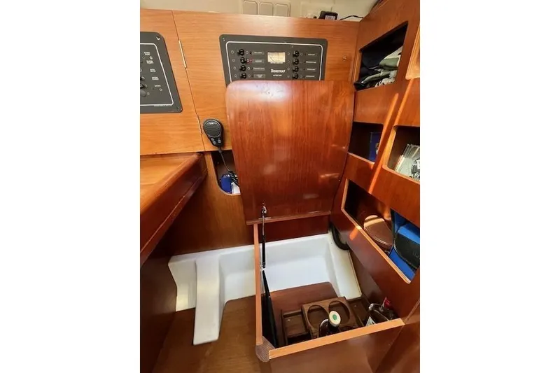 Slide: The Image of 2005 Beneteau First 36.7 yacht interior with wooden cabinetry and storage compartments. - 34