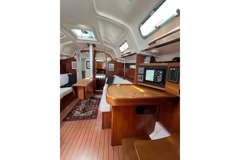 Slide: The Image of Interior of 2005 Beneteau First 36.7 sailboat with wood finish and navigation equipment. - 35
