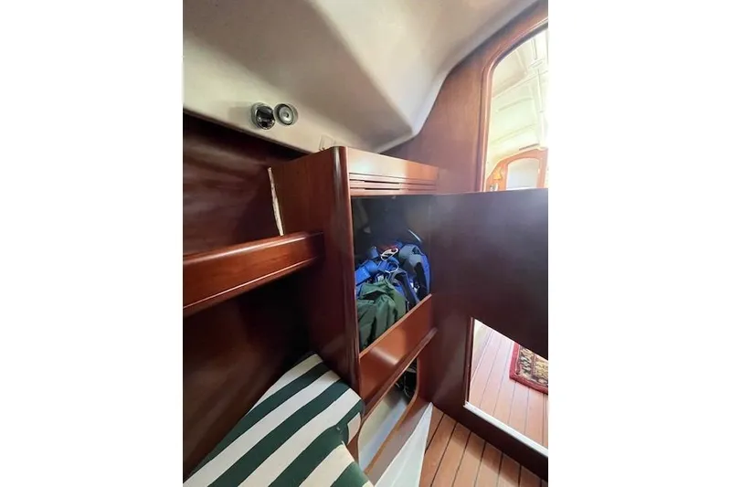 Slide: The Image of Interior cabin storage on a 2005 Beneteau First 36.7 sailboat, featuring wooden cabinetry. - 39