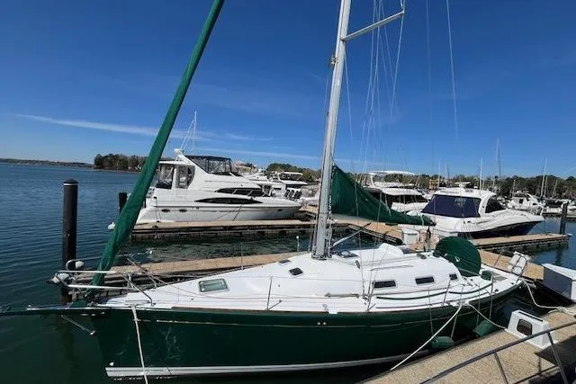 Slide: The Image of 2005 Beneteau First 36.7 sailboat docked at marina under clear blue sky. - 4