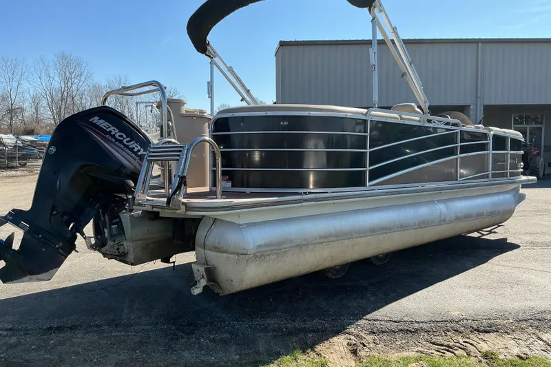 Slide: The Image of 2015 Berkshire 230E STS pontoon boat with Mercury outboard motor, parked outdoors. - 4
