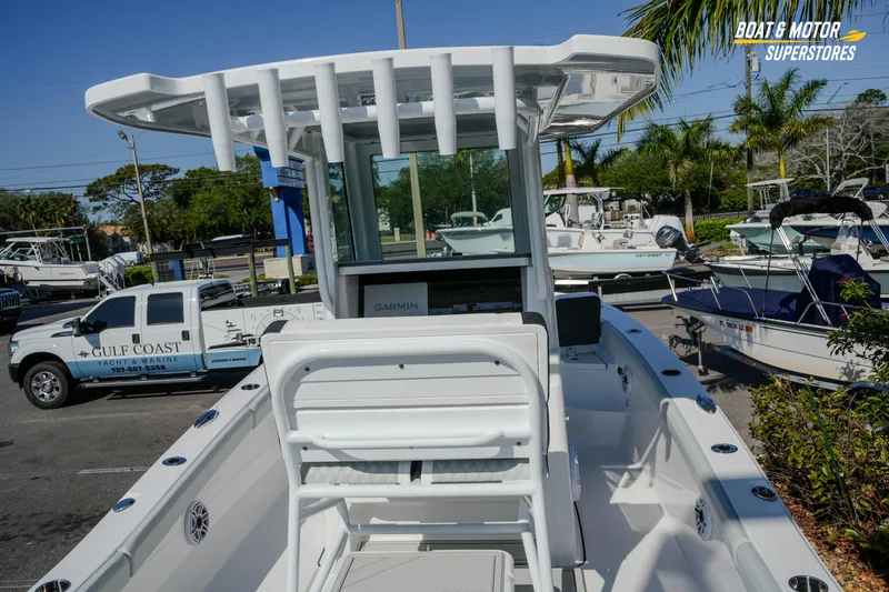 Slide: The Image of 2026 Blackfin 242 HB boat at dealership, featuring sleek design and advanced Garmin navigation. - 10