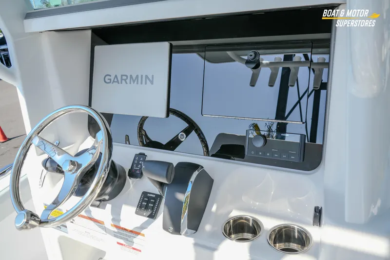 Slide: The Image of 2026 Blackfin 242 HB boat dashboard with Garmin navigation system and steering wheel. - 13